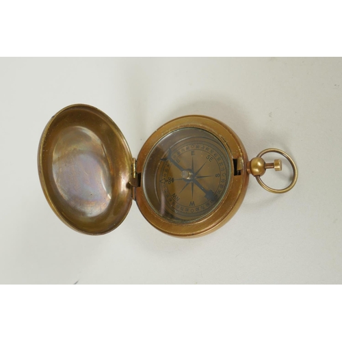 186 - A brass and leather miniature terrestrial globe desk stand, and a replica brass compass, 27cm high