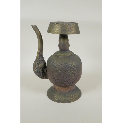 191 - A Tibetan embossed bronzed metal pourer with raised kylin decoration, 26cm high