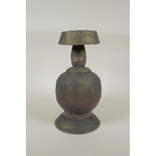 191 - A Tibetan embossed bronzed metal pourer with raised kylin decoration, 26cm high