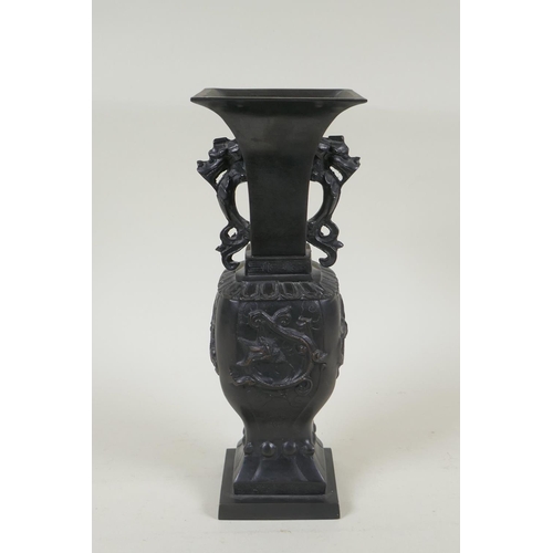 192 - A Japanese bronze vase with twin dragon handles and raised dragon decoration to the side, indistinct... 