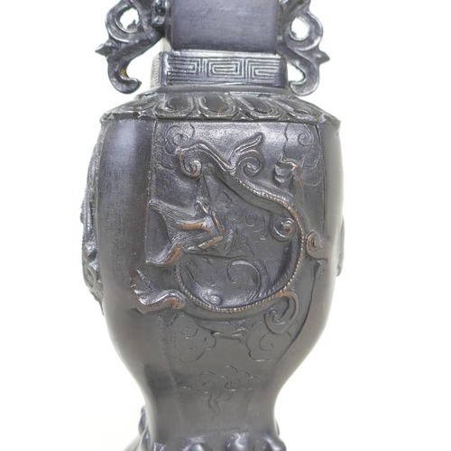 192 - A Japanese bronze vase with twin dragon handles and raised dragon decoration to the side, indistinct... 