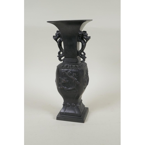 192 - A Japanese bronze vase with twin dragon handles and raised dragon decoration to the side, indistinct... 