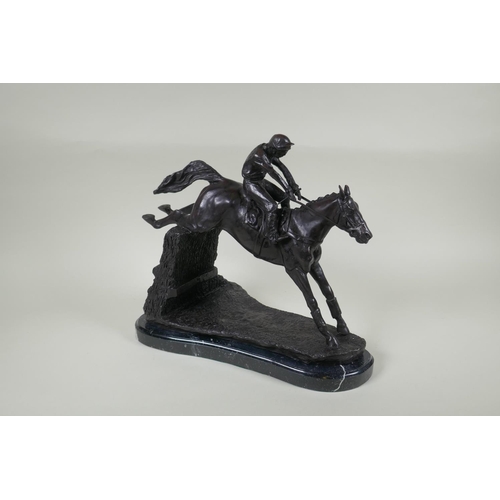 194 - A bronze figure of a horse and jockey, 32cm high