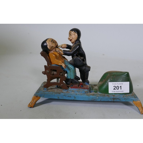 201 - A painted cast iron money box in the form of a dentist, 22cm long, 16cm high