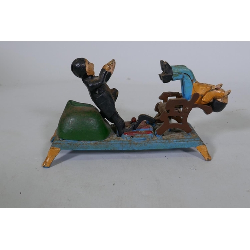 201 - A painted cast iron money box in the form of a dentist, 22cm long, 16cm high