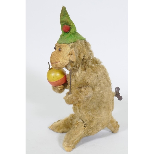 208 - A vintage clockwork monkey, 25cm high