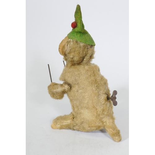 208 - A vintage clockwork monkey, 25cm high