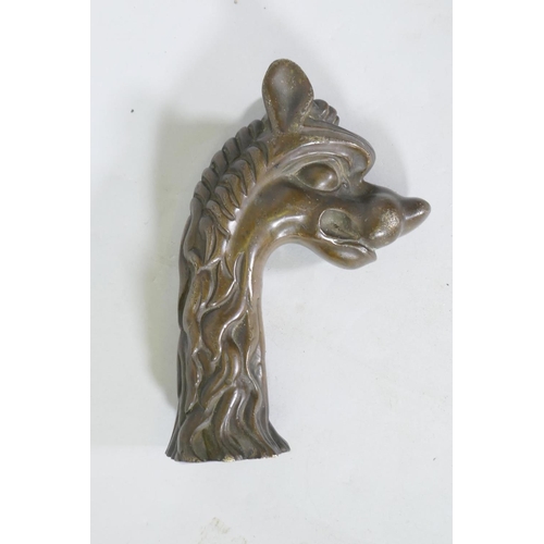 209 - Antique bronze mount in the form of a dragon's head, 17cm long