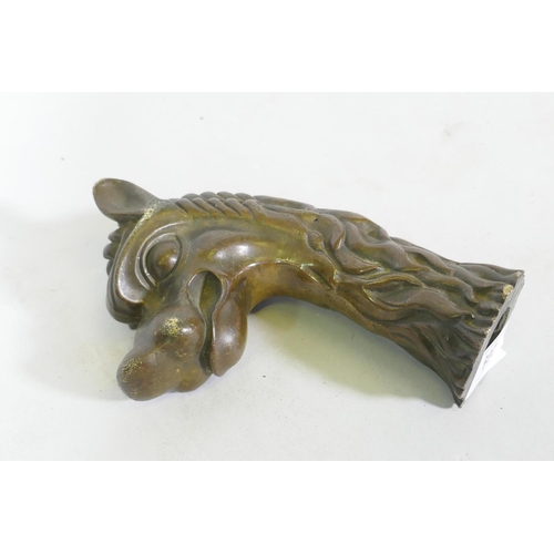 209 - Antique bronze mount in the form of a dragon's head, 17cm long