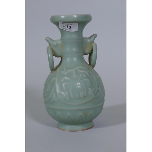 216 - A Chinese celadon glazed vase with raised lotus flower decoration, 23cm high