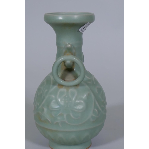 216 - A Chinese celadon glazed vase with raised lotus flower decoration, 23cm high