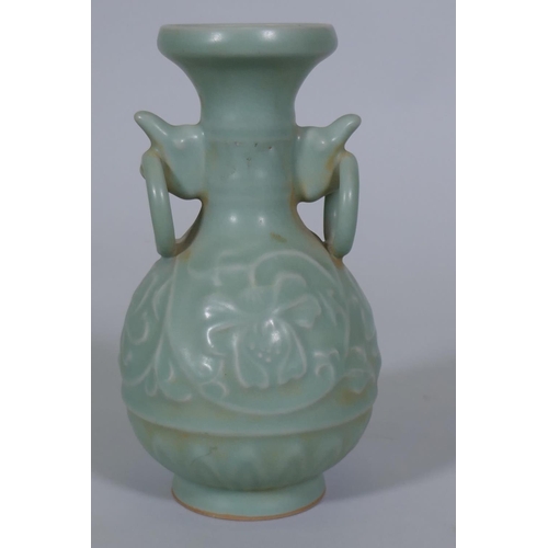 216 - A Chinese celadon glazed vase with raised lotus flower decoration, 23cm high