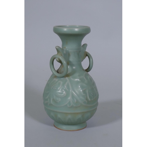 216 - A Chinese celadon glazed vase with raised lotus flower decoration, 23cm high