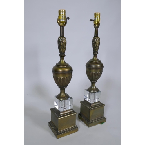 217 - A pair of bronzed and crystal glass table lamps, 63cm high