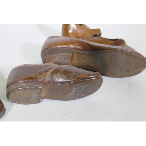 219 - A pair of late C19th/early C20th child's leather shoes, 12cm long, and another pair larger