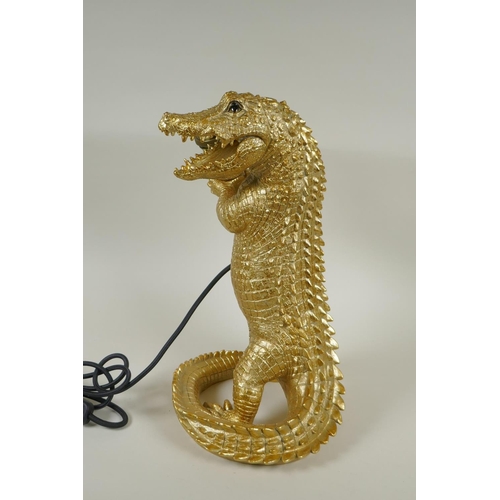 222 - A gilt composition lamp in the form of a crocodile, 38cm high