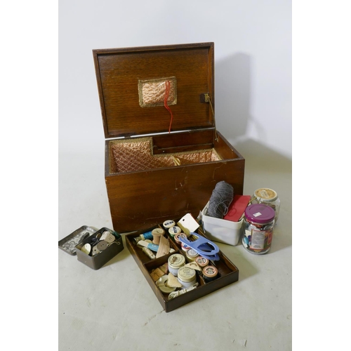 224 - An oak workbox containing vintage buttons and threads, 38 x 28 x 23cm