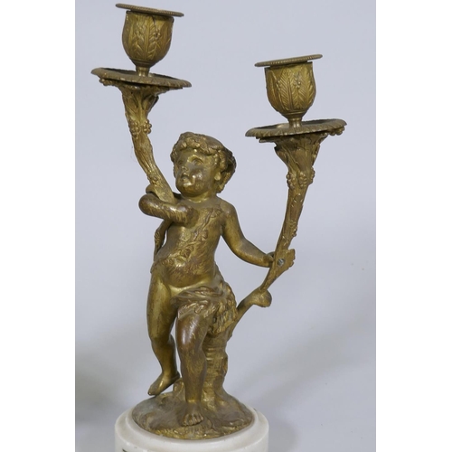 227 - A pair of C19th French ormolu bronze two branch candelabra in the form of putti bearing cornucopia, ... 