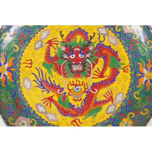 228 - A Chinese cloisonne dish decorated with a dragon and flaming pearl, 25cm diameter