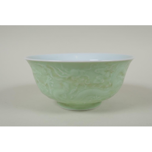 231 - A Chinese celadon glazed porcelain rice bowl with underglaze dragon decoration, 5 character mark to ... 