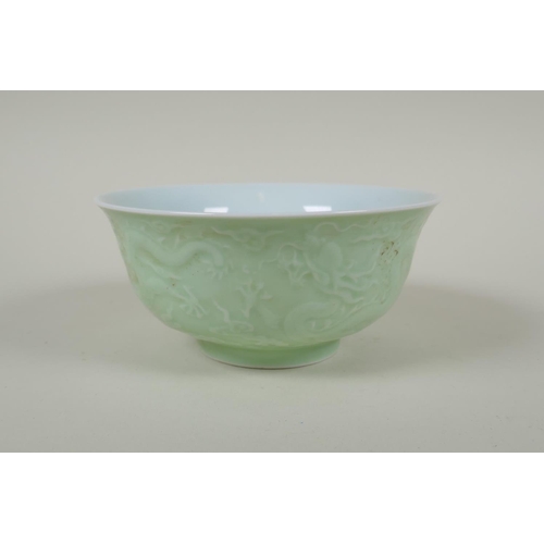 231 - A Chinese celadon glazed porcelain rice bowl with underglaze dragon decoration, 5 character mark to ... 