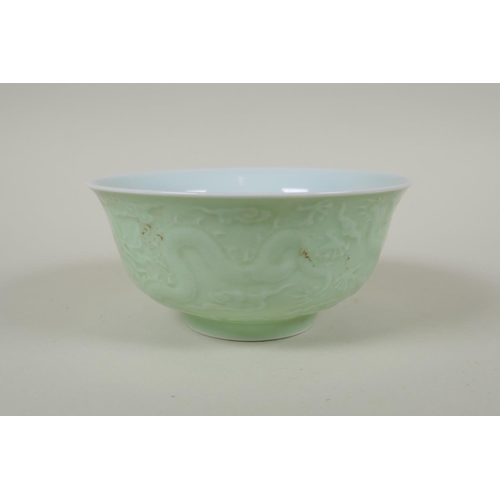 231 - A Chinese celadon glazed porcelain rice bowl with underglaze dragon decoration, 5 character mark to ... 