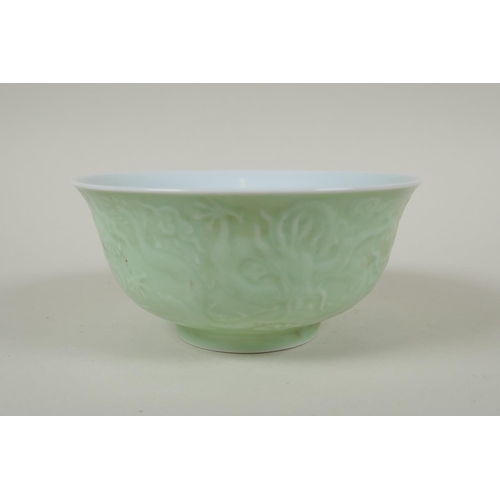 231 - A Chinese celadon glazed porcelain rice bowl with underglaze dragon decoration, 5 character mark to ... 