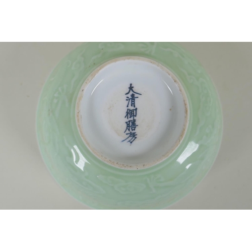 231 - A Chinese celadon glazed porcelain rice bowl with underglaze dragon decoration, 5 character mark to ... 