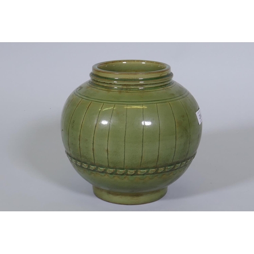 234 - A Chinese green crackle glazed jar with ribbed decoration, 23cm high