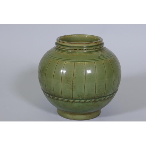 234 - A Chinese green crackle glazed jar with ribbed decoration, 23cm high