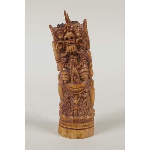 244 - A Balinese bone carving of a female wrathful deity, 11cm high