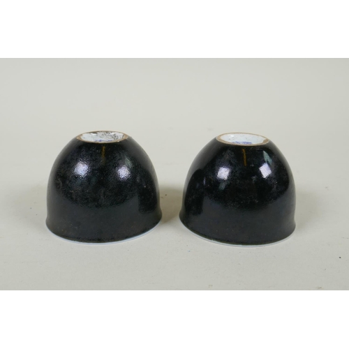 245 - A pair of Chinese black glazed porcelain tea bowls, 4 character mark to base, 6.5cm diameter