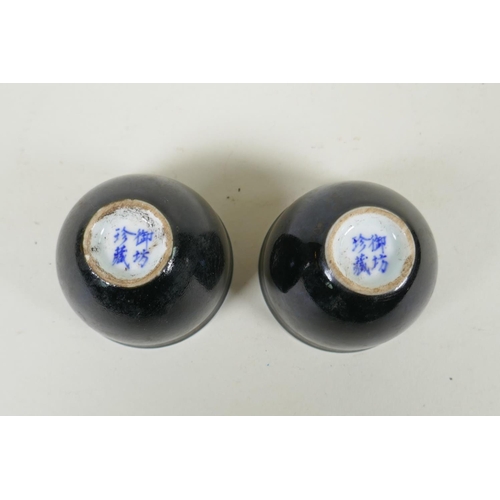 245 - A pair of Chinese black glazed porcelain tea bowls, 4 character mark to base, 6.5cm diameter