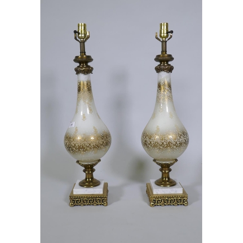 246 - A pair of silver plated glass table lamps with brass mounts and marble base, 70cm high