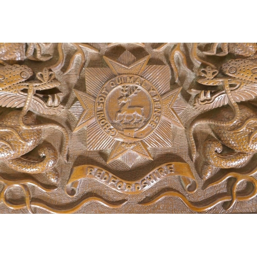 25 - A Kashmiri/Burmese carved box inscribed with the regimental badge of the Bedfordshire Regiment, and ... 