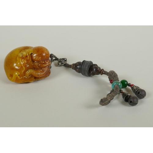 258 - A Chinese reconstituted amber soapstone elephant and monkey pendant/toggle, 7cm long