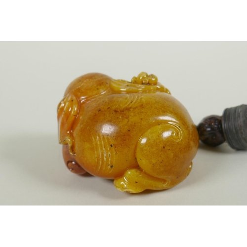 258 - A Chinese reconstituted amber soapstone elephant and monkey pendant/toggle, 7cm long