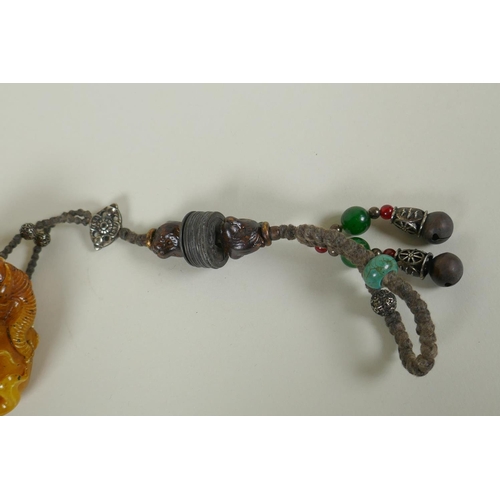 258 - A Chinese reconstituted amber soapstone elephant and monkey pendant/toggle, 7cm long