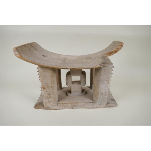 261 - An African Ashanti tribe carved wood stool and another smaller, both first half of the C20th, AF rep... 