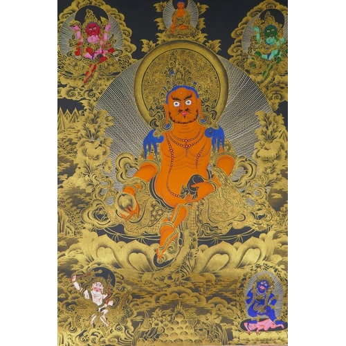 262 - A Tibetan painted thangka depicting Jambhala, housed within a silk mount, 80 x 124cm