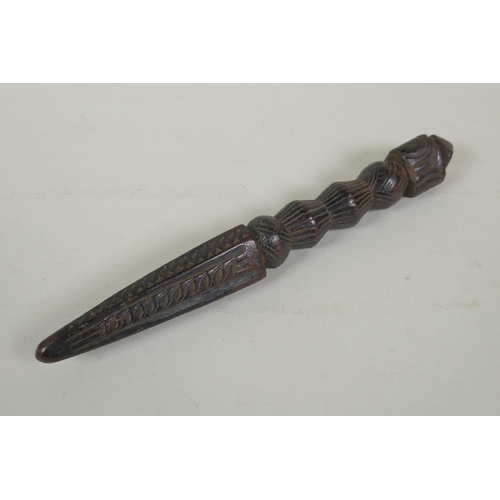 264 - An antique Tibetan ceremonial carved hardwood phurba, 23cm