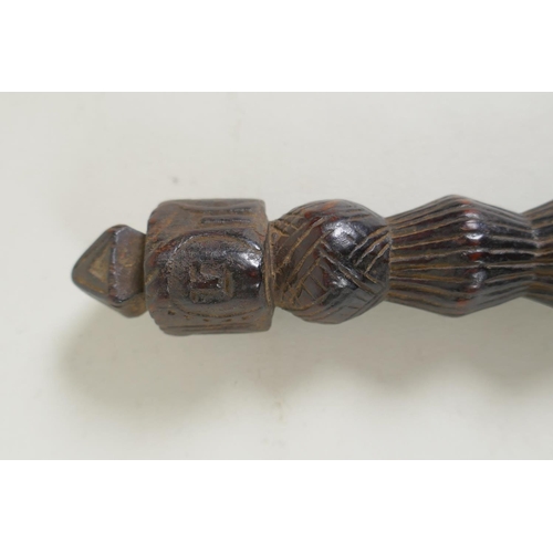 264 - An antique Tibetan ceremonial carved hardwood phurba, 23cm