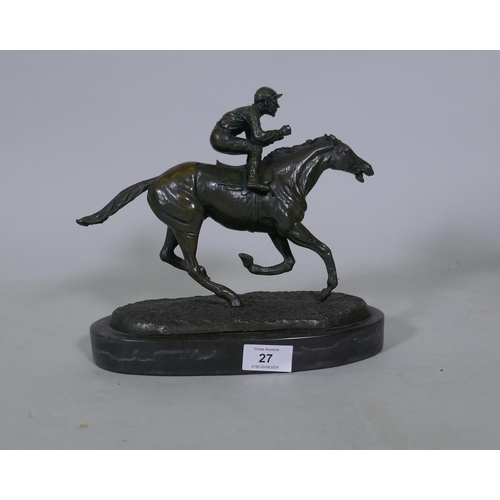 27 - A bronze figure of a jockey on a racehorse, inscribed Coreira, mounted on a slate base, 24cm high