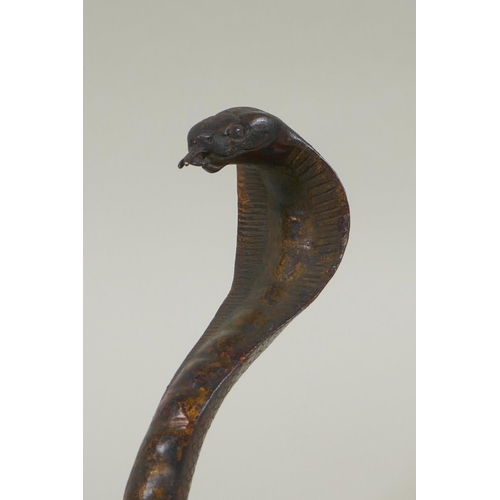 287 - A Tibetan gilt bronze figure of a cobra, 18cm high