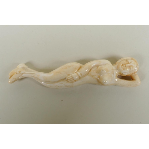 293 - An oriental carved bone figure of a female nude, 13cm long