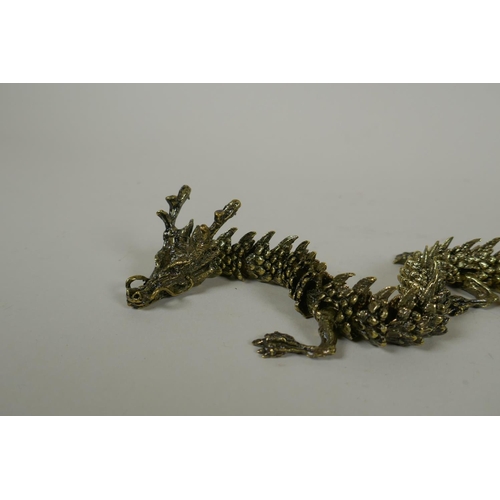 30 - A Japanese Jizai style bronze okimono dragon with articulated body and limbs, 42cm long