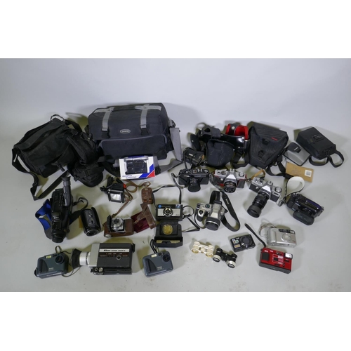 300 - A quantity of vintage cameras, film cameras and equipment, including a Kodak 255X Instamatic, a Koda... 