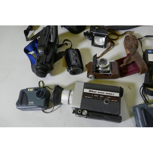 300 - A quantity of vintage cameras, film cameras and equipment, including a Kodak 255X Instamatic, a Koda... 