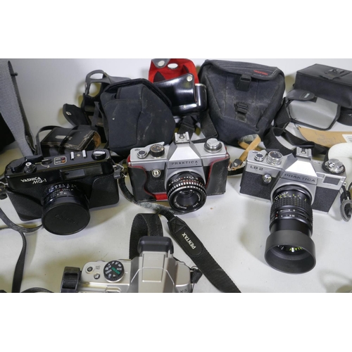 300 - A quantity of vintage cameras, film cameras and equipment, including a Kodak 255X Instamatic, a Koda... 