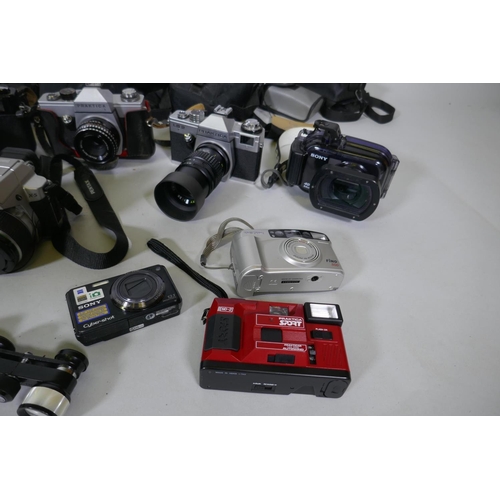 300 - A quantity of vintage cameras, film cameras and equipment, including a Kodak 255X Instamatic, a Koda... 